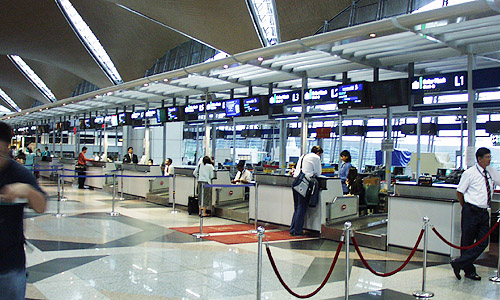 このカウンターは、シンガポール航空（SQ）とマレーシア航空（MH）の共同チェックインカウンターです。取材時はSQ117便のキャンセル待ち時間でした
